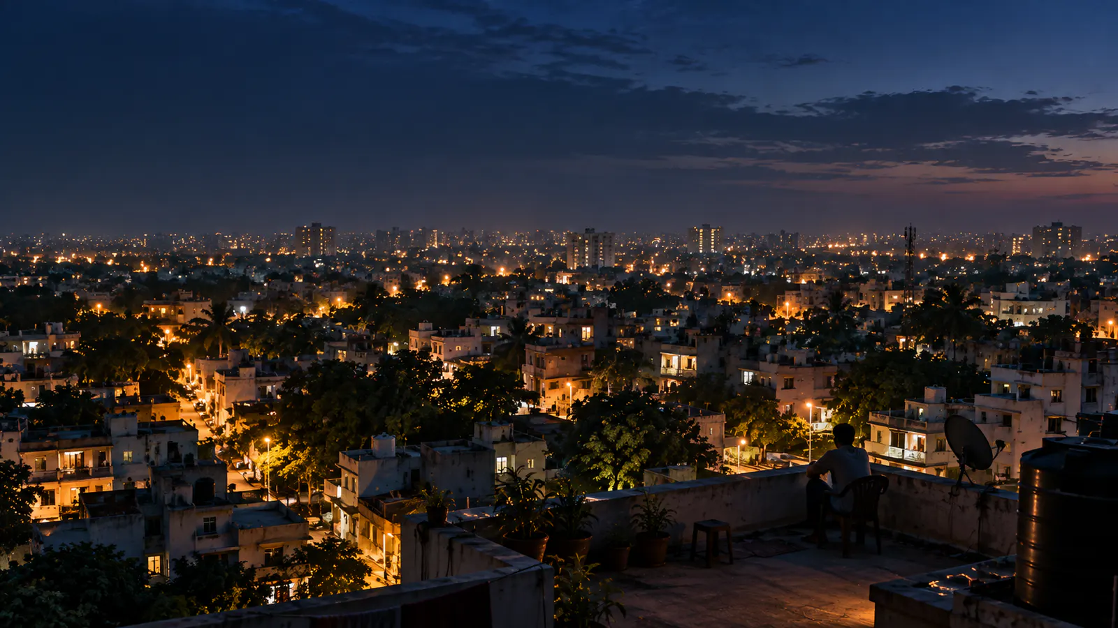 Conceptual rooftop view across neighbourhood lights and a distant city skyline at blue hour.